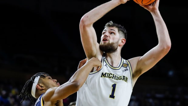Michigan center Hunter Dickinson (1) goes to the basket against Toledo guard Dante Maddox Jr. (21) during the second half of the first round of the NIT at Crisler Center in Ann Arbor on Tuesday, March 14, 2023.